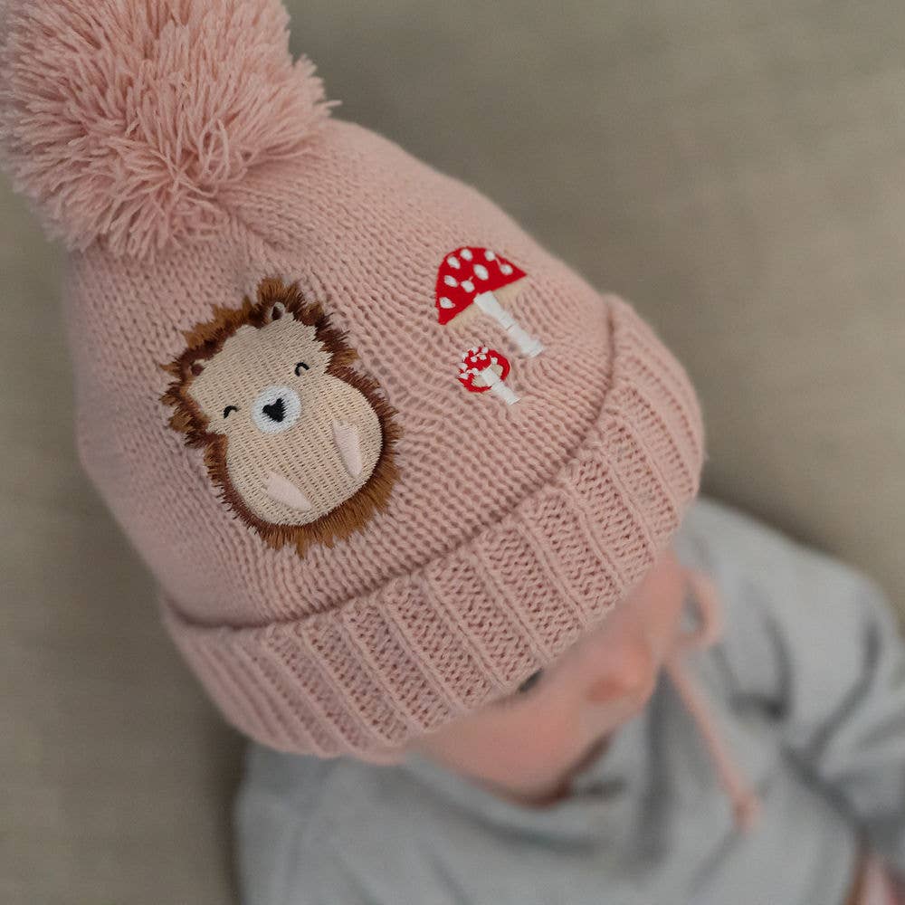 Baby wearing woodland wooly hat and mittens