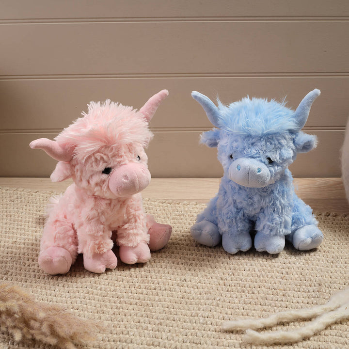 Sitting plush Highland cow soft toy in pink and blue