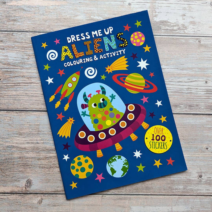 Child using Dress Me Up Aliens colouring and activity book
