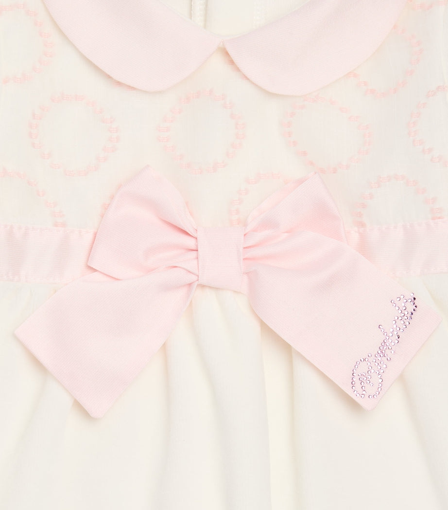 Bimbalò Rosa pink baby romper with jacquard bodice, long sleeves and press-stud fastening