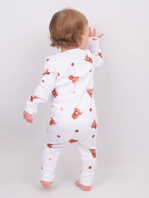 Baby wearing BabyMac Scottish Highland Cow sleepsuit